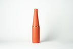 Duet water bottle with a coffee cup stored on the base. Coral-coloured product shown on a white background.