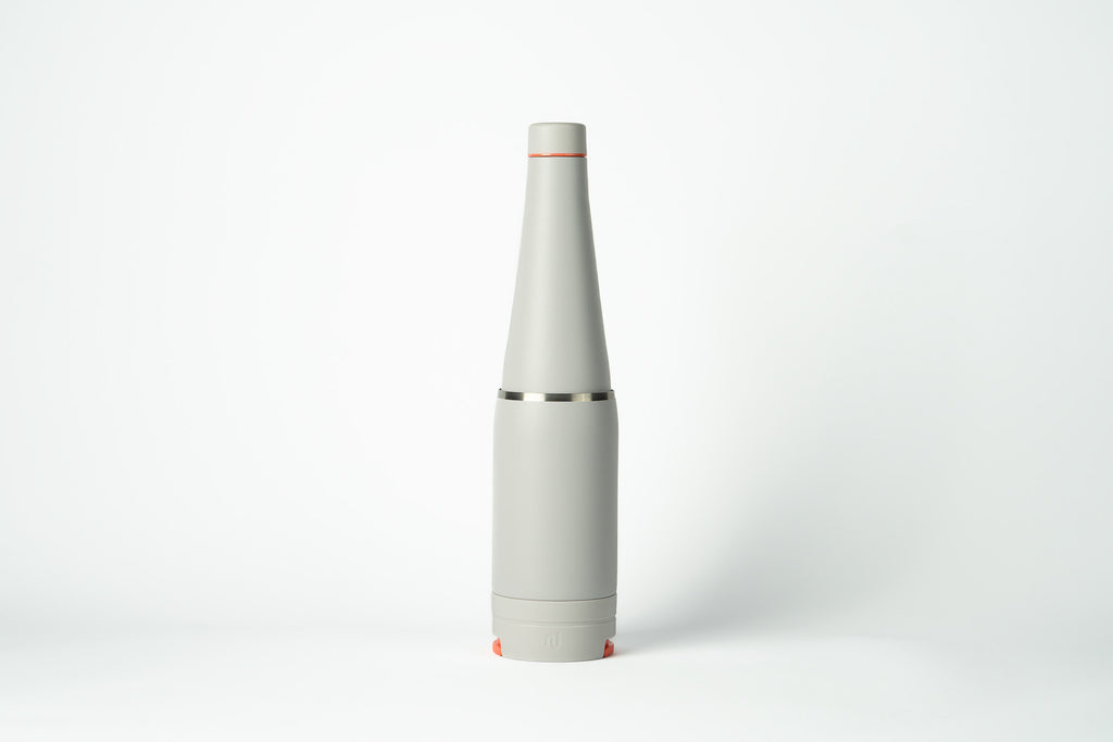 Light grey Duet water bottle with coffee cup stored on the base, shown on a white background.