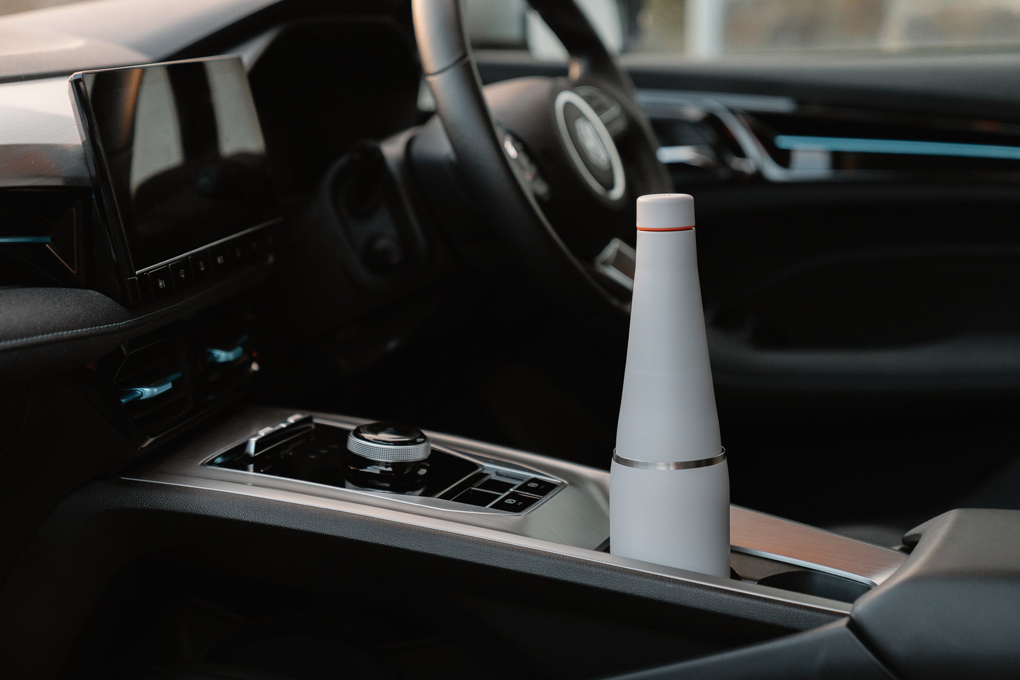 Fully assembled grey Duet coffee cup and water bottle system positioned in a car cup holder.