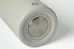 Close-up of a grey Duet water bottle showing branding and capacity markings, on a white background.