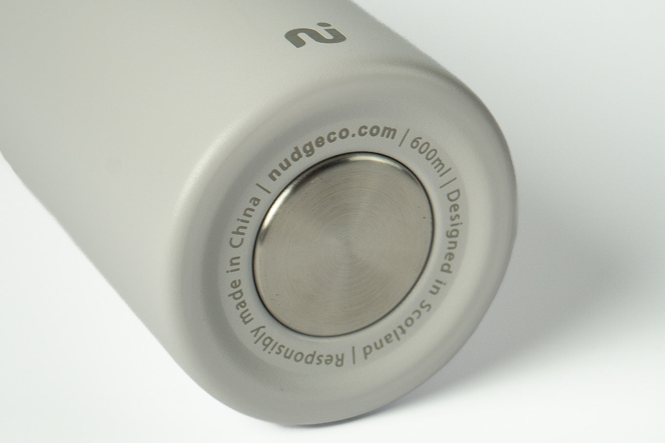 Close-up of a grey Duet water bottle showing branding and capacity markings, on a white background.